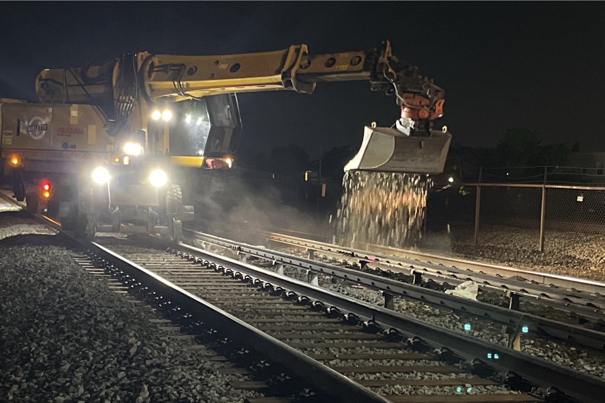 Truck performing construction on rails