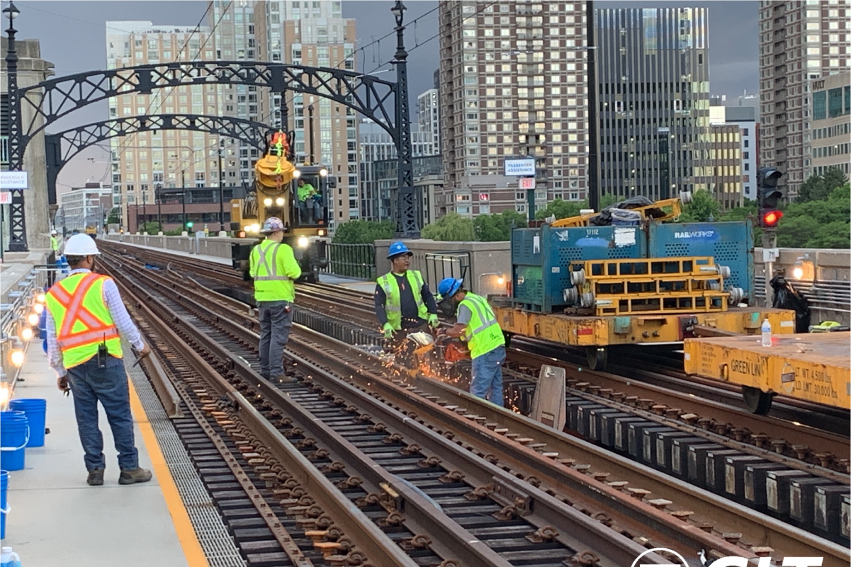 crew members cutting rail on an overcast day