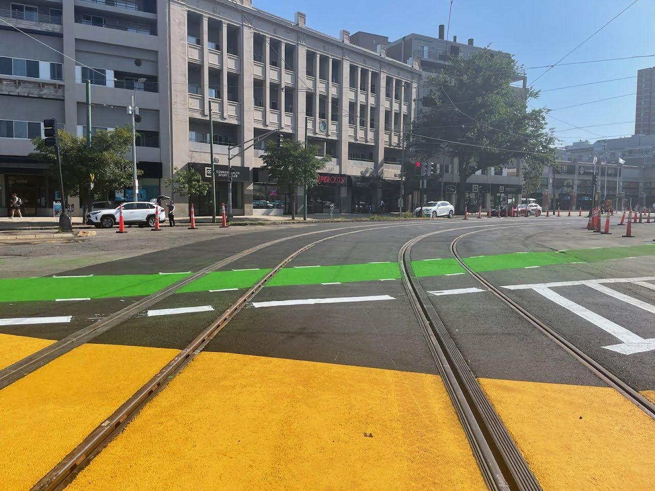 fresh rail, asphalt, and paint on street at packard's corner