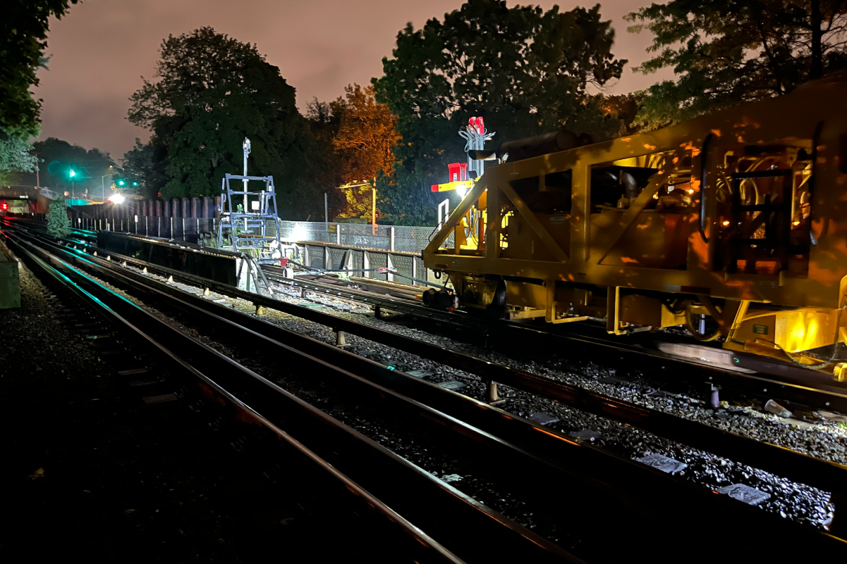 equipment on tracks under floodlights at night