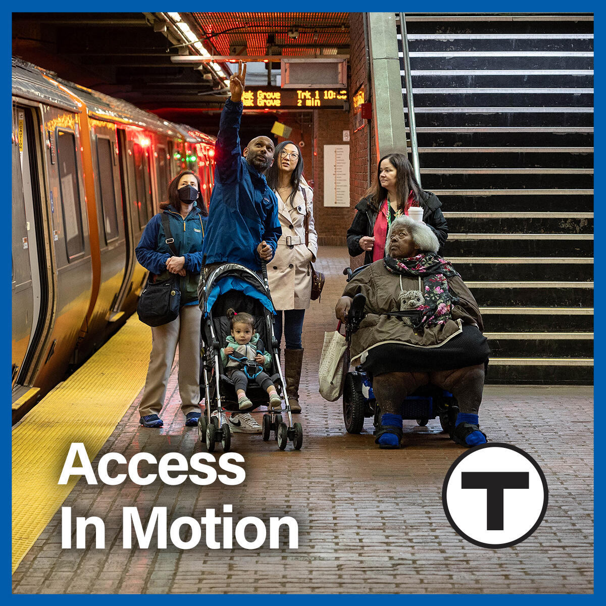 On an Orange Line platform, a group of riders look up at the digital signage as a train idles on the track beside them. The group includes a white woman wearing a mask; an ambulatory Asian American woman; a South Asian man pushing a stroller; an African American woman using a wheelchair; and a white woman standing behind the African American woman using a wheelchair. The tagline “Access in Motion” and the T logo appear in the foreground.
