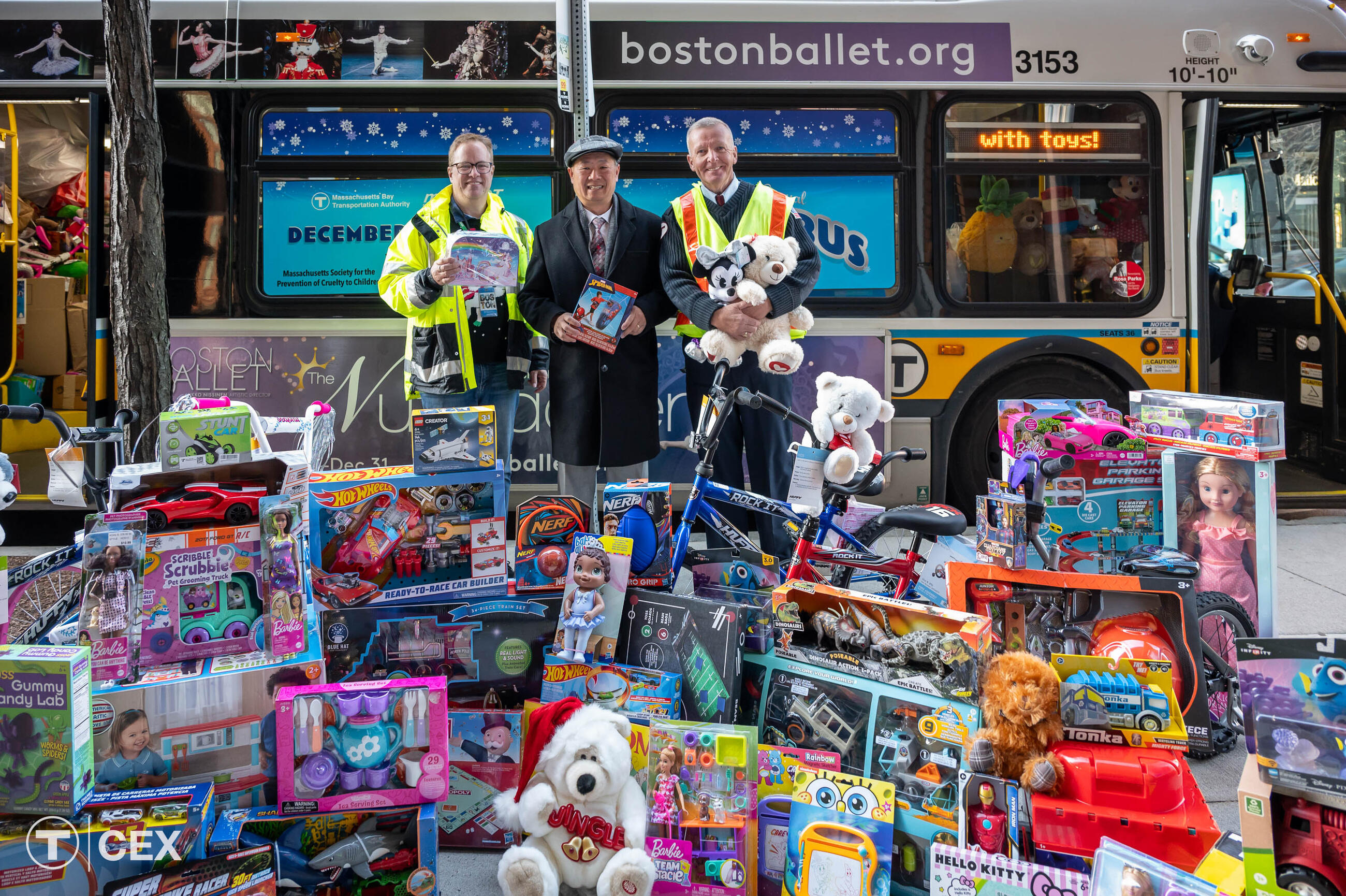 Left to Right: MBTA Graphics Manager David Wood, who has organized the Fill-A-Bus with Gifts event for the last six years; MBTA General Manager and CEO Phillip Eng; and MBTA Bus Operator Mike Broderick, who drives the holiday bus route each year.