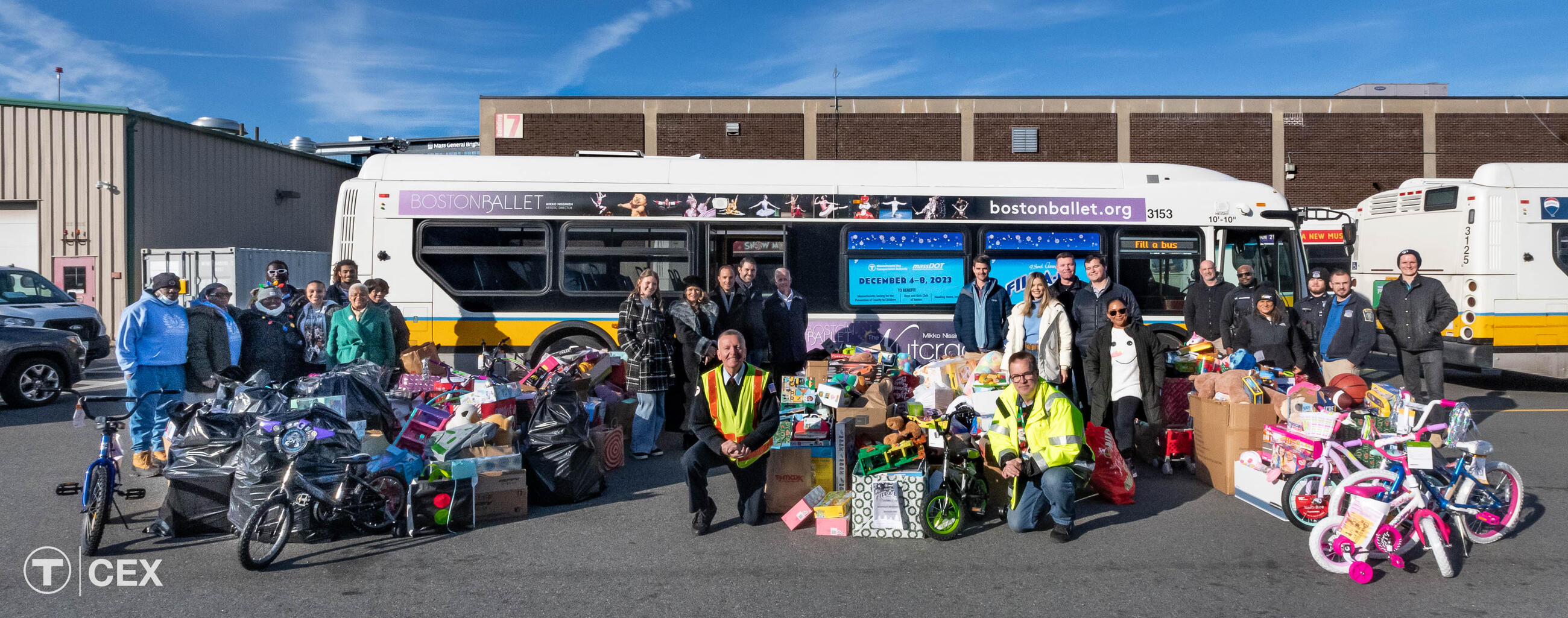 MBTA staff, Event Organizer and MBTA Graphics Manager David Wood, MBTA Holiday Bus Route Operator Mike Broderick, and others gathered for 23rd Annual Fill-A-Bus with Gifts holiday drive.