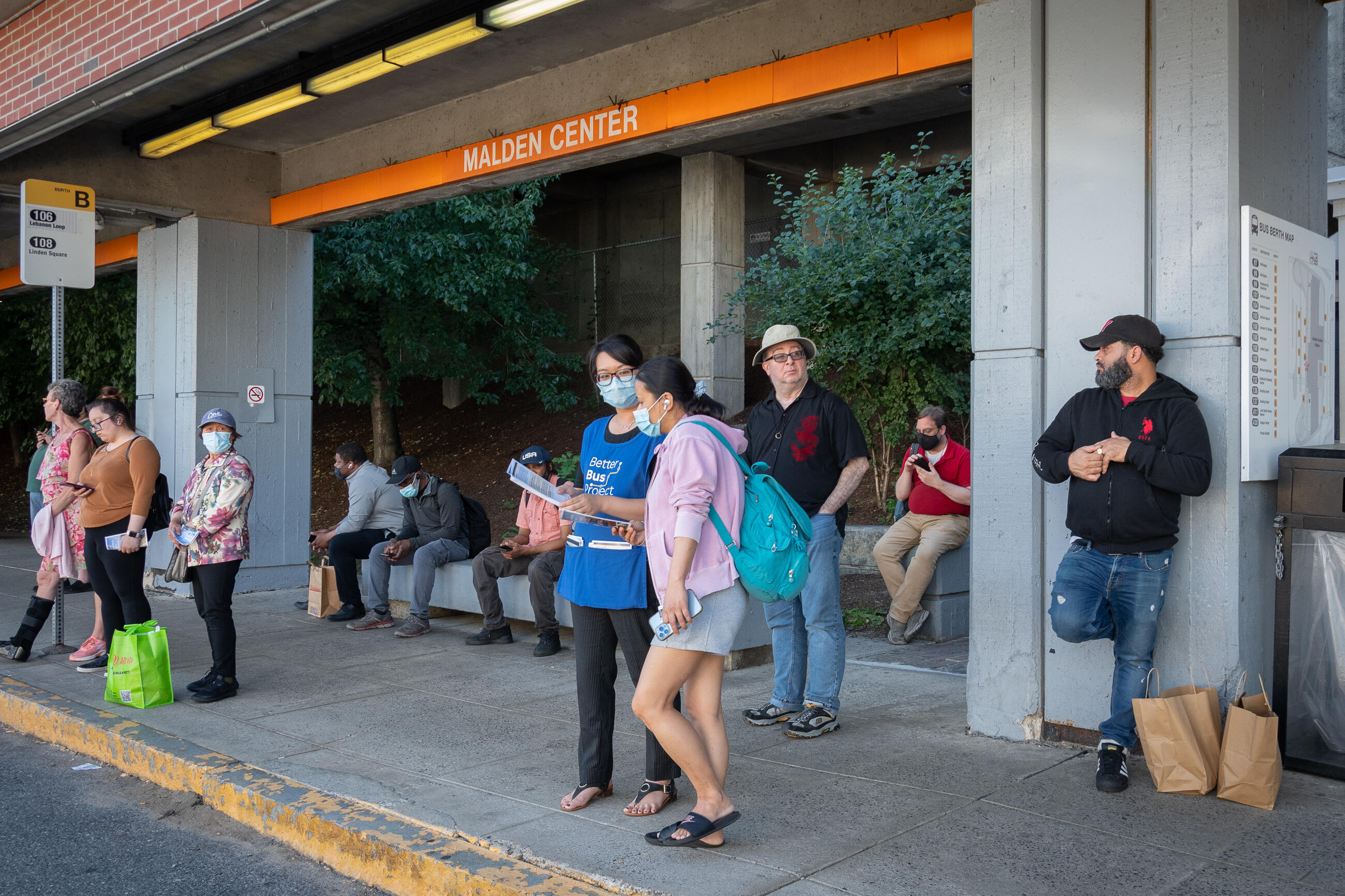 Bus riders waiting at bus stop