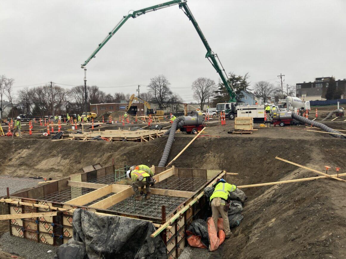 Workers digging and building the foundation at Quincy Bus Maintenance Facility site.