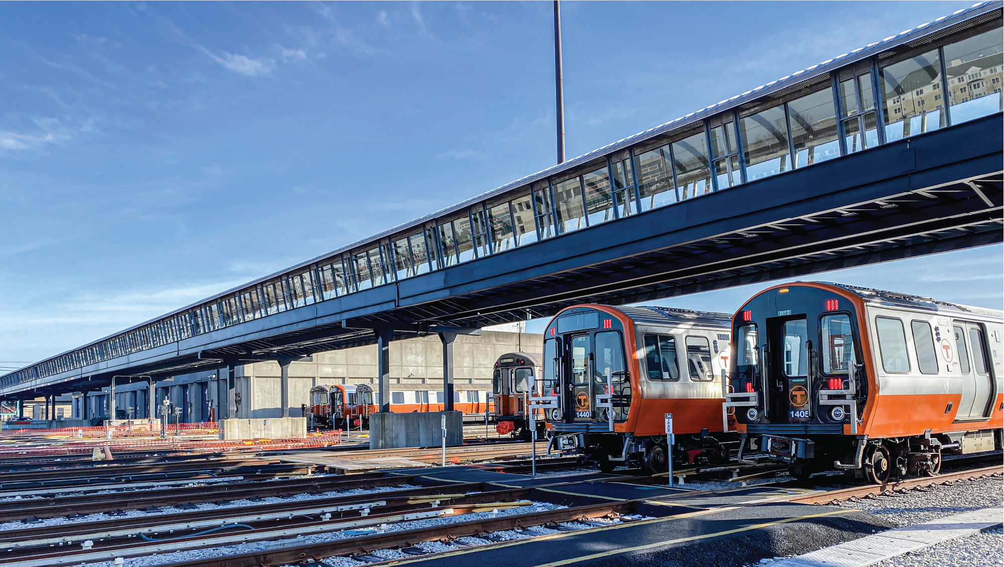 Orange line cars lined up in a yard