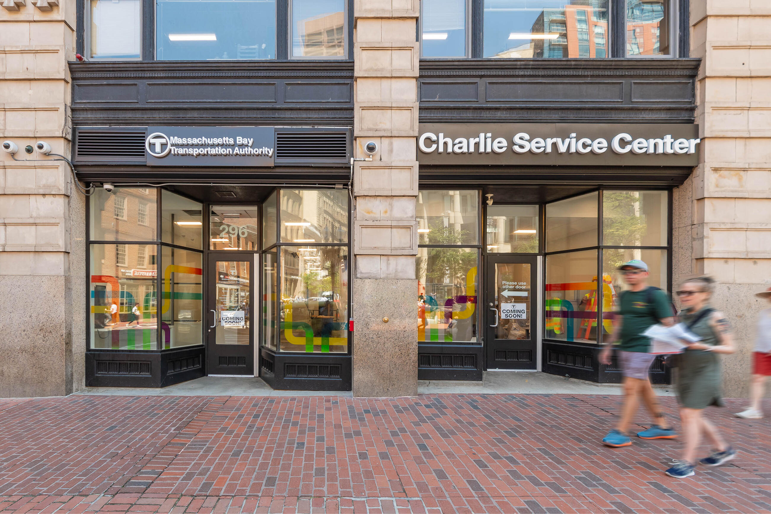 Front of the Charlie Service Center with two pedestrians walking by