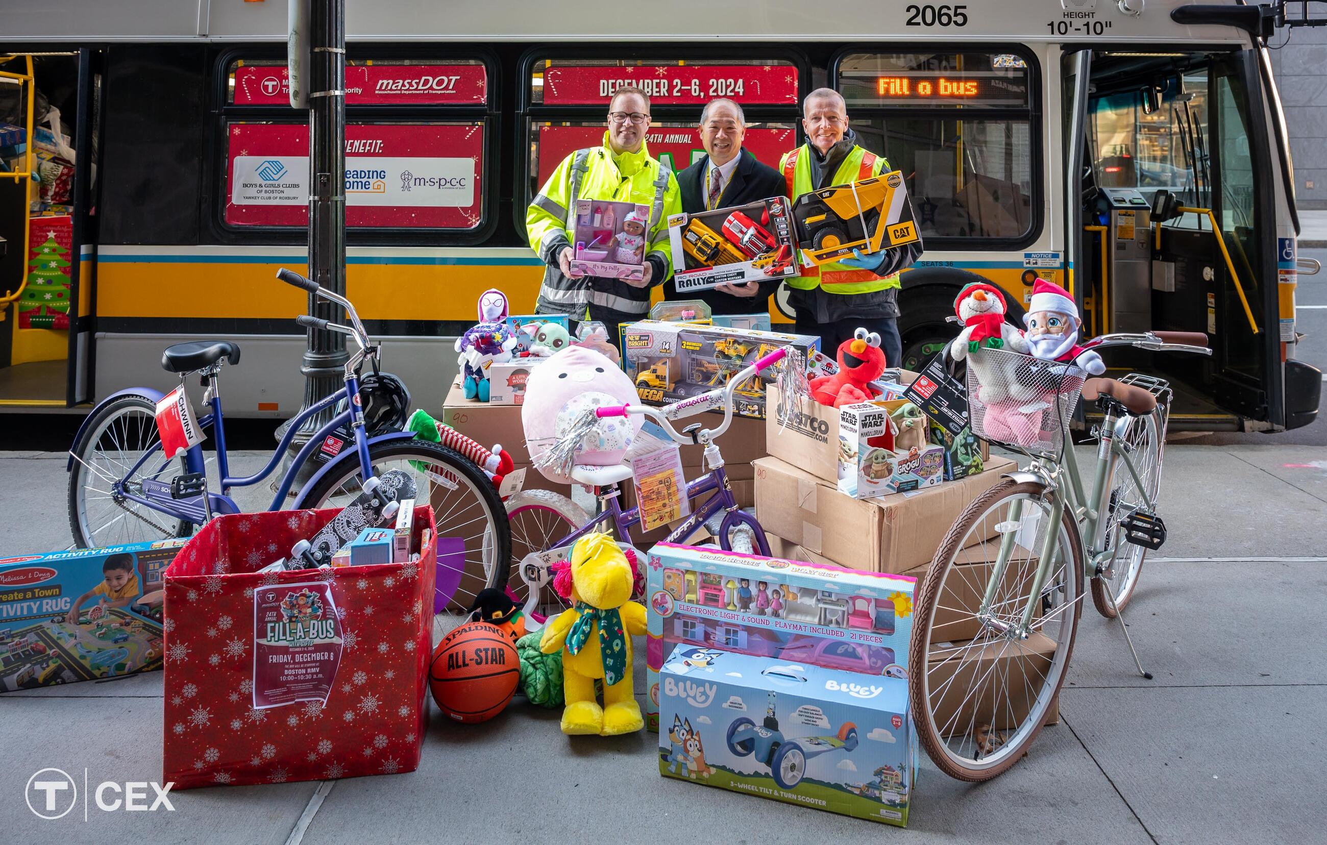  Left to Right: MBTA Graphics Manager David Wood, who has organized the Fill-A-Bus with Gifts event for the last seven years; MBTA General Manager and CEO Phillip Eng; and MBTA Bus Operator Mike Broderick, who drives the holiday bus route each year. Complimentary photo by the MBTA Customer and Employee Experience Department.