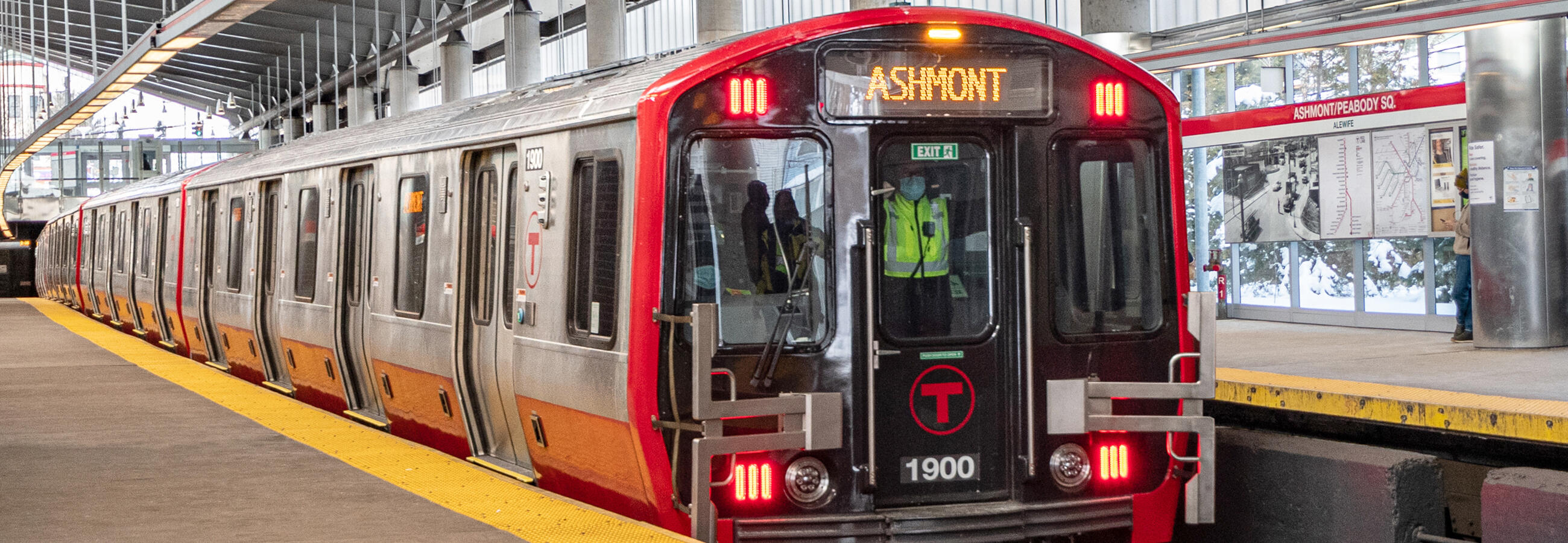 Red train car with a headway sign reading Ashmont