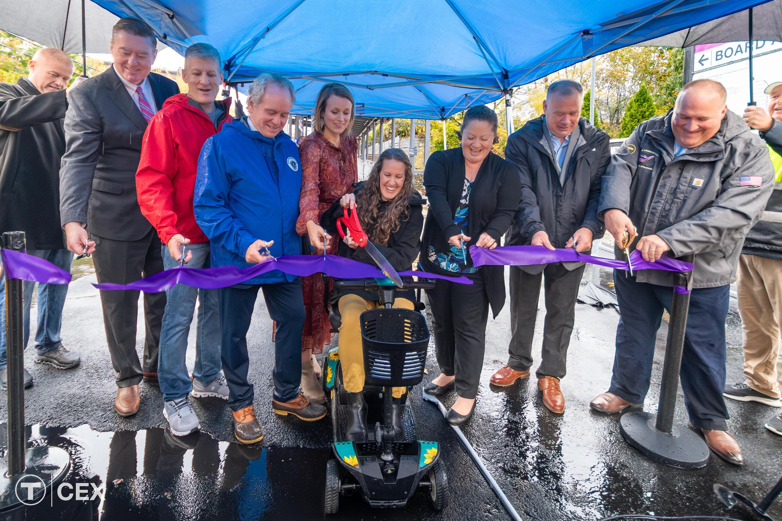 MBTA Leadership, Franklin officials, and community advocates cut a ribbon at Franklin Station