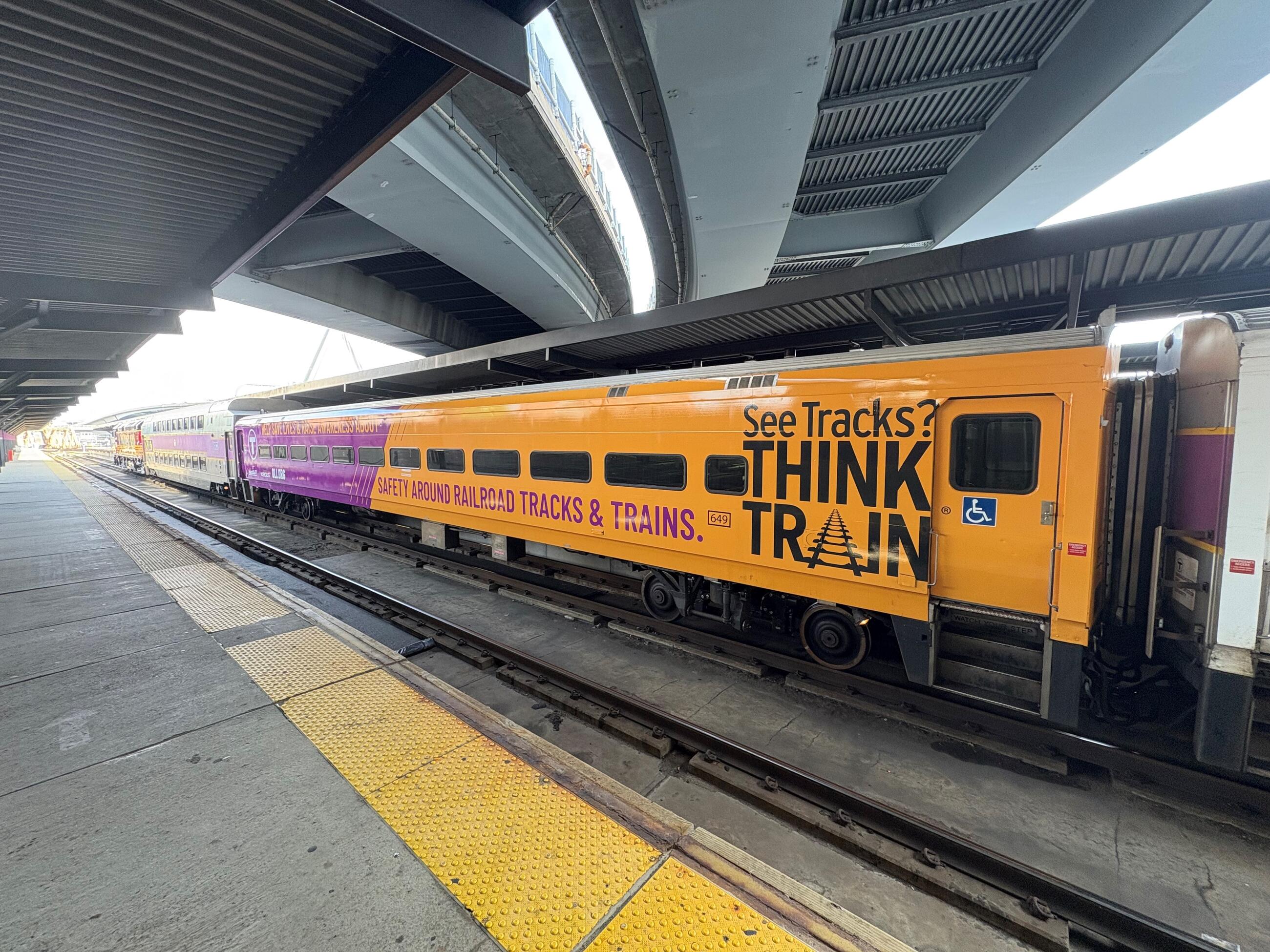 Commuter Rail Coach wrapped in See Tracks Think Train messaging