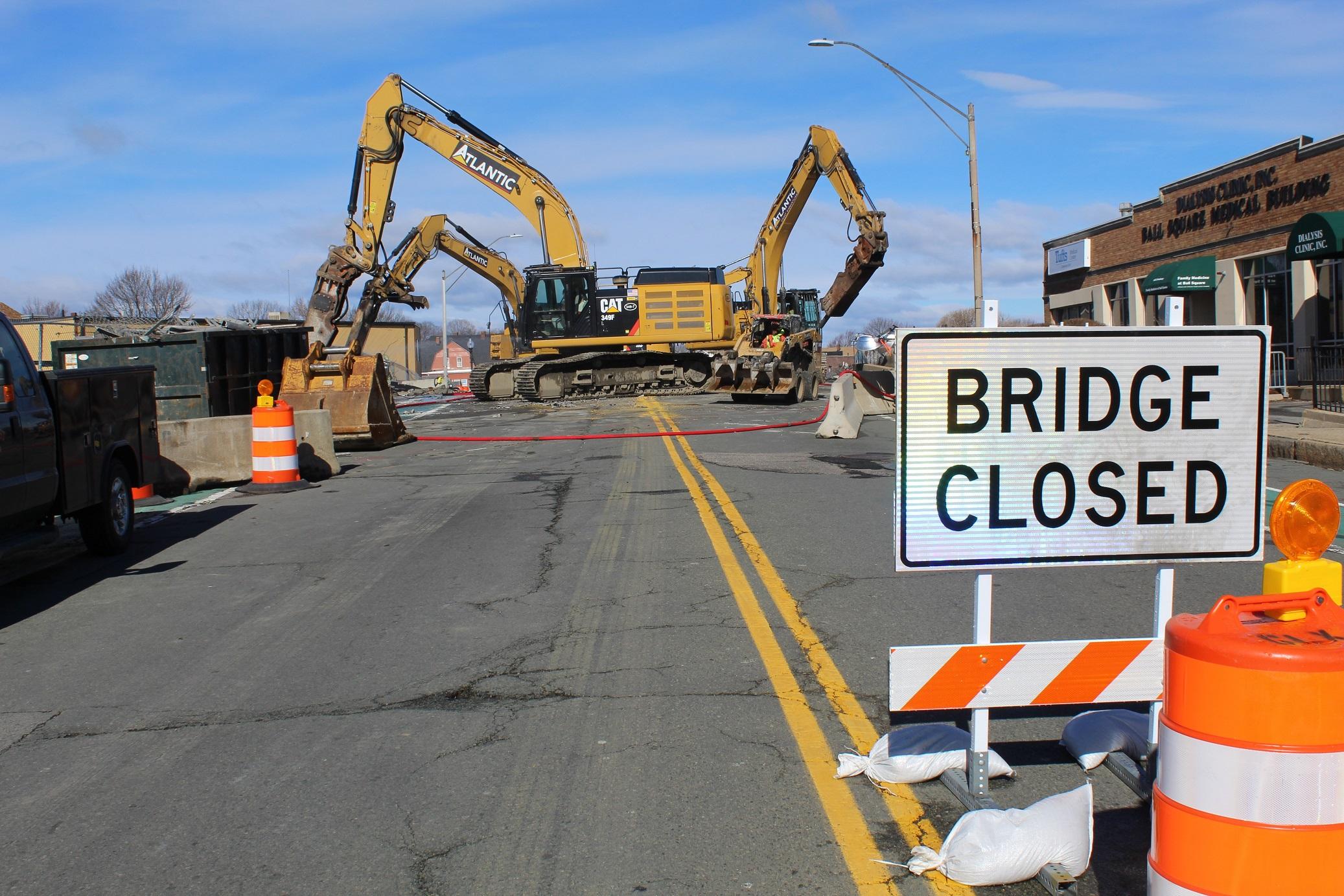 Demolition heavy machinery on the Broadway Bridge, with a BRIDGE CLOSED sign in the foreground.