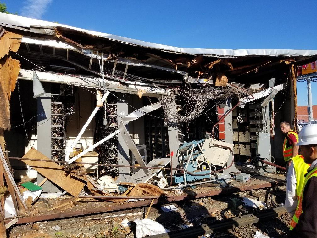 Crews inspect damage to the signal house at JFK/UMass