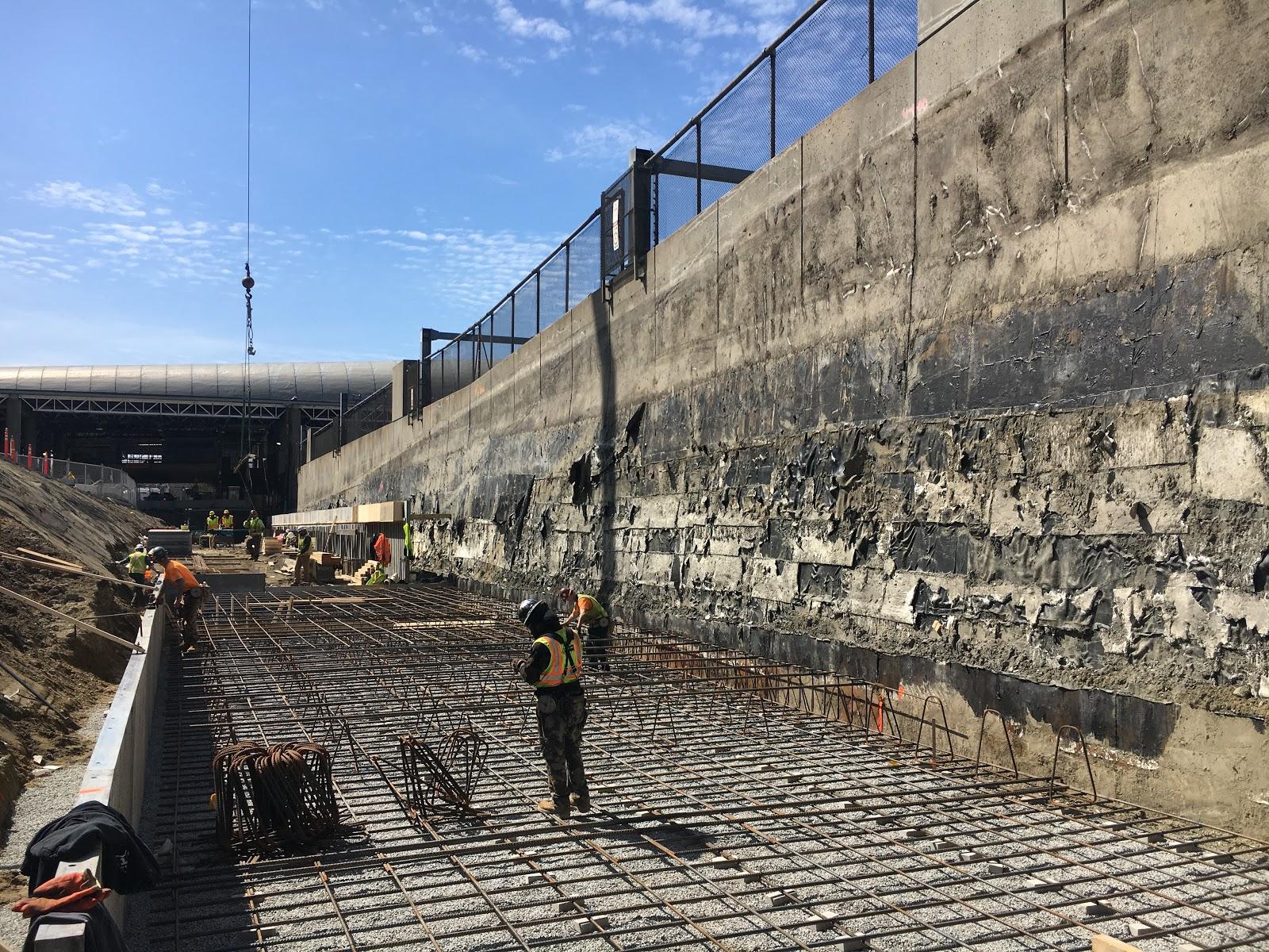 A construction crew works on the Ruggles Commuter Rail platform