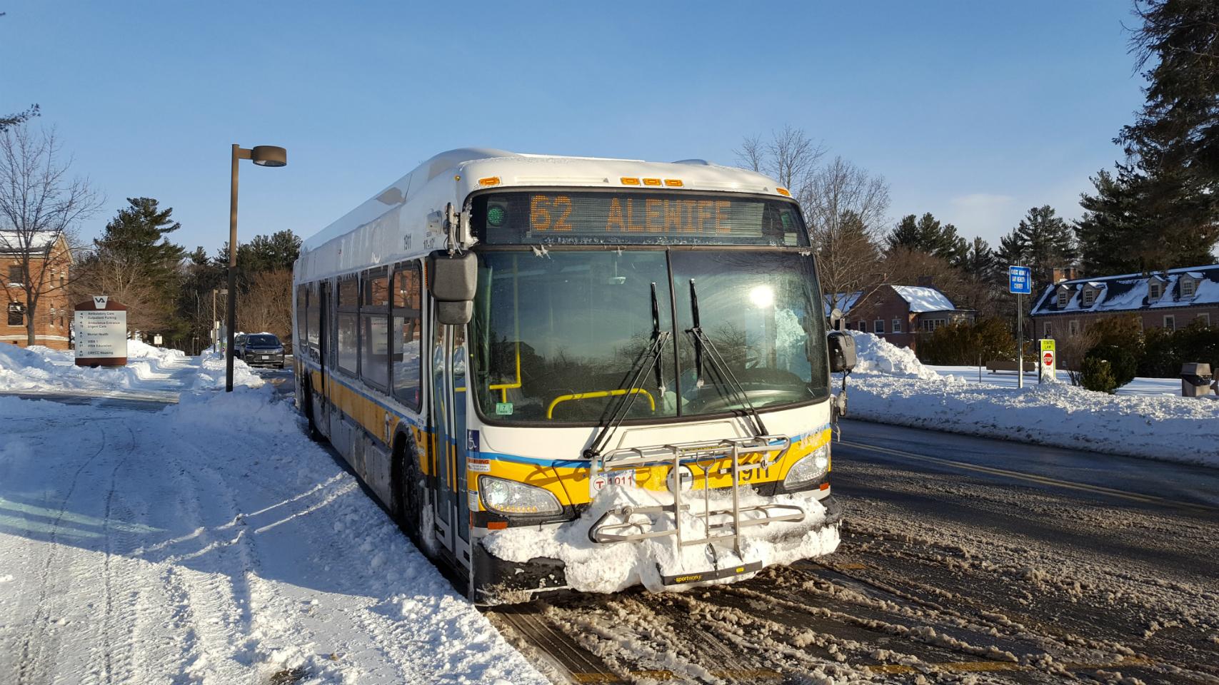 Bus in winter, with snow on the grass, the road cleared