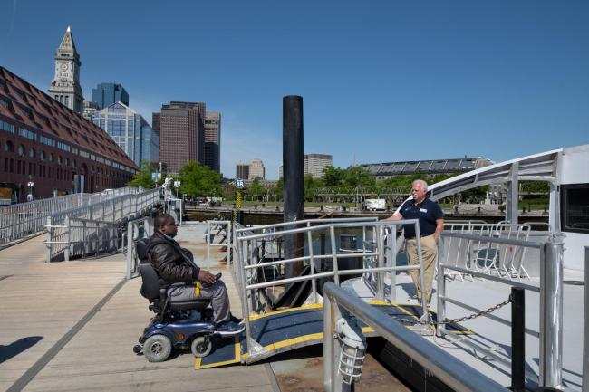 customer boarding ferry using bridge plate