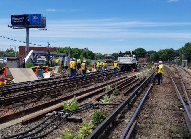 Crew repair tracks and signals at jfk/umass station