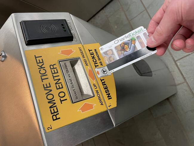 Old paper CharlieTickets have a black magnetic stripe on the front and can only be inserted at legacy fare gates.
