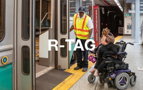 A rider in a wheeled mobility device boards a Green Line train using a bridge plate.