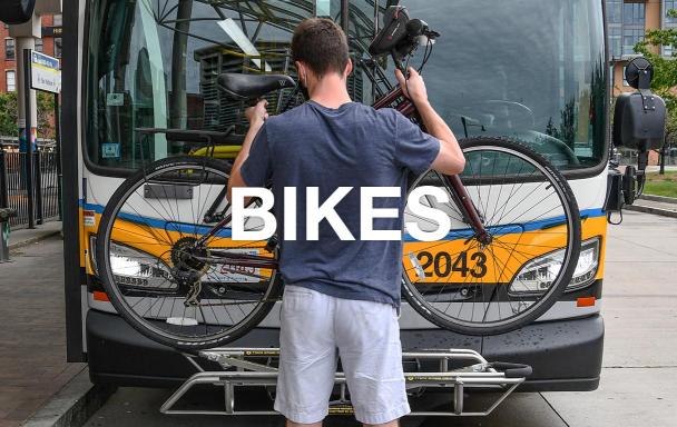 Overlaid text reads "Bikes." A rider mounts his bike on a bus bike rack.