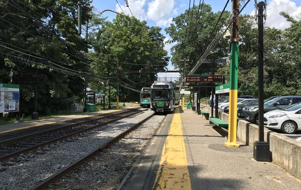 A Green Line train at the Waban station. The entire platform and tracks are visible