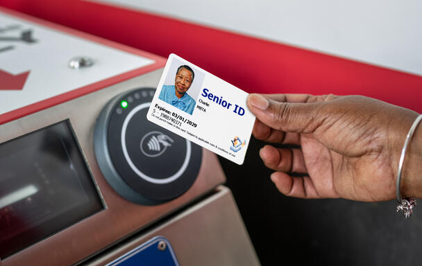 A rider uses a reduced fare Senior CharlieCard on the Red Line