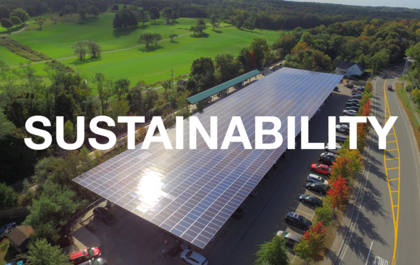 Overlaid text reads "Sustainability." Aerial view of the T's solar canopy covering a parking lot in West Hingham is in the background.
