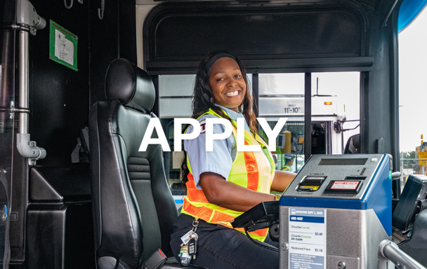 A seated bus operator smiles in the driver's seat. Overlay text reads Apply.