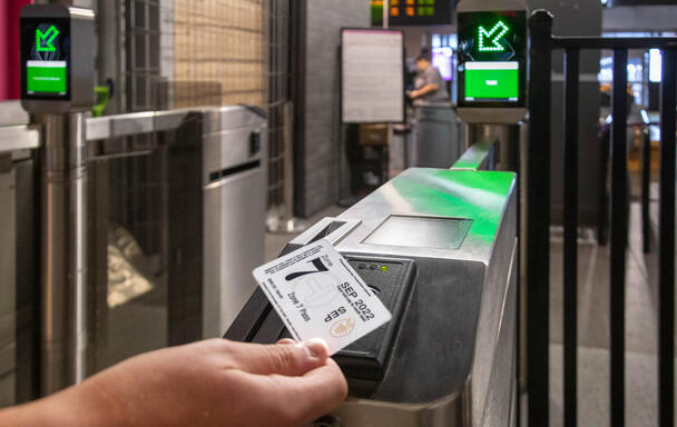 Rider using tappable ticket on new fare gate in North Station