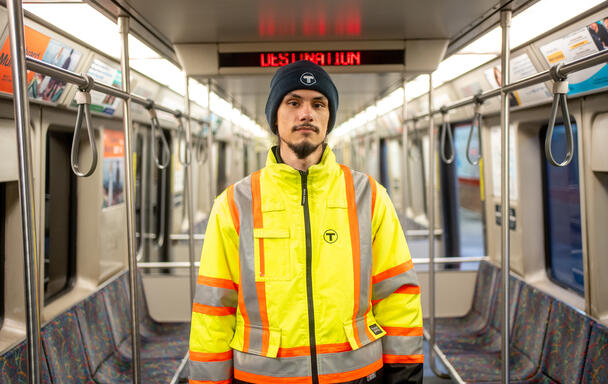 Motorperson Antonio Juarez standing inside a Red Line vehicle