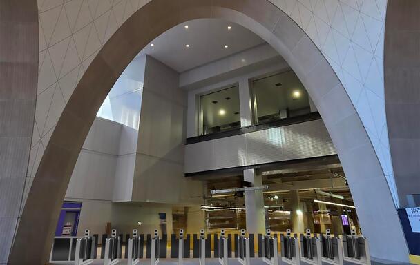A line of fare gates under an arch