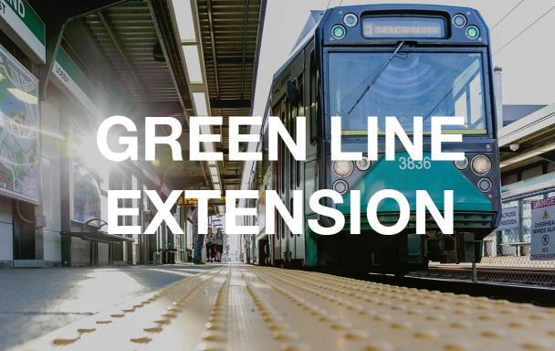 Green Line train pulls into Science Park. Text overlaid: Green Line Extension.